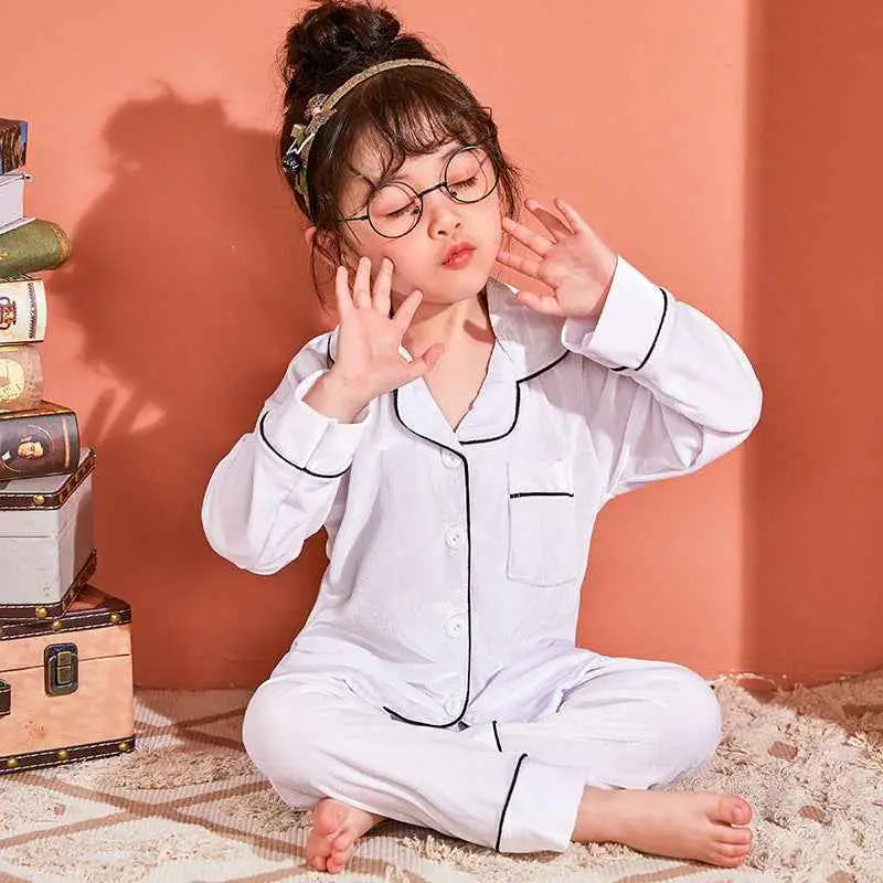 White children’s pajama set with black piping details made from gold velvet cotton by trend den White