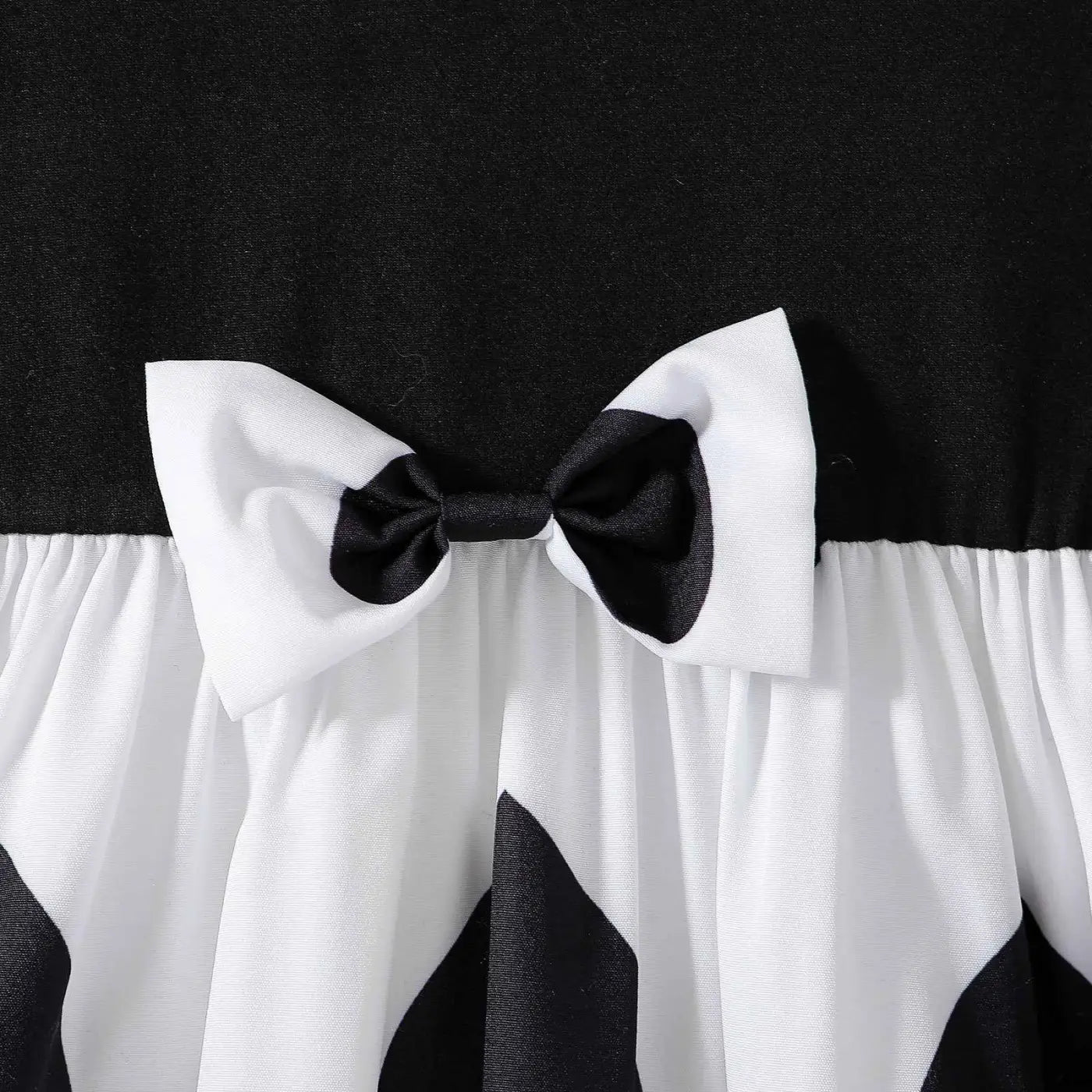 Black and white satin bow adorns the waist of a girls cartoon princess dress from trend den