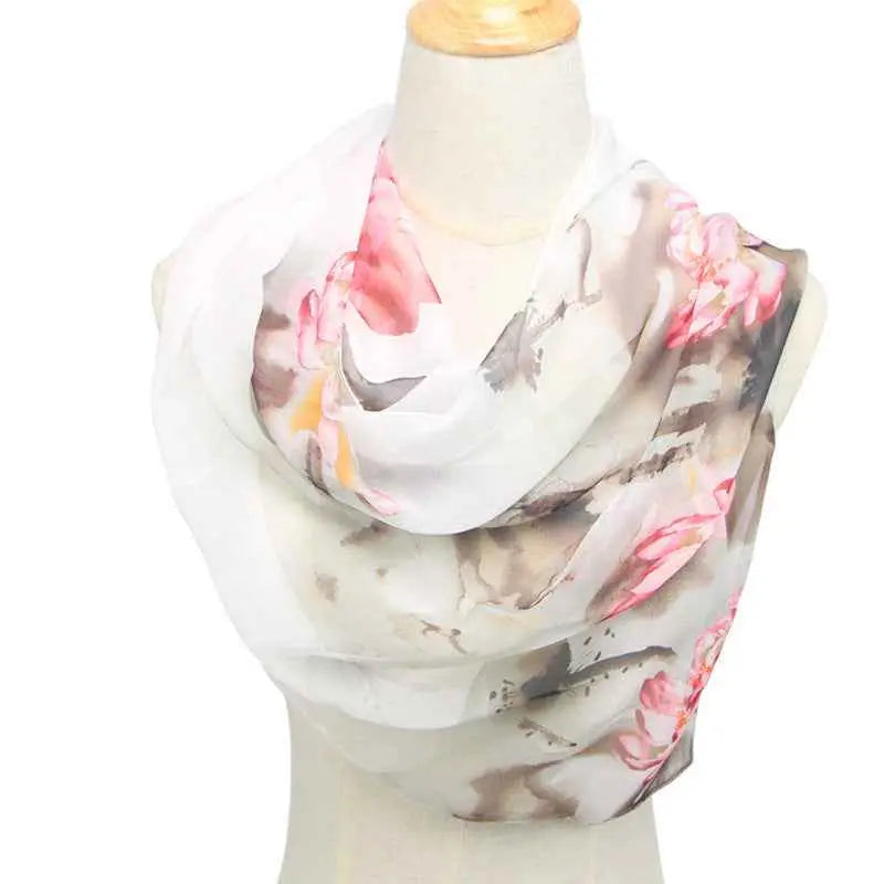 A delicate white chiffon sunscreen scarf with retro ethnic floral pink blossoms and muted gray accents White