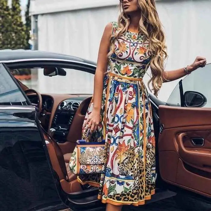 Sleeveless retro print cake dress by Dolce & Gabbana with bold floral and leopard print in multicolored hues and gold trim