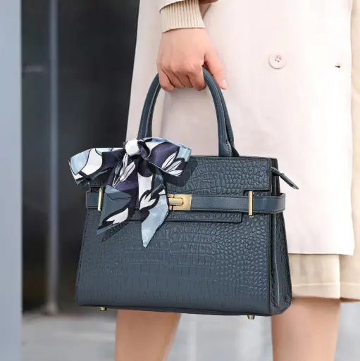 A lady carrying a navy blue leather bag