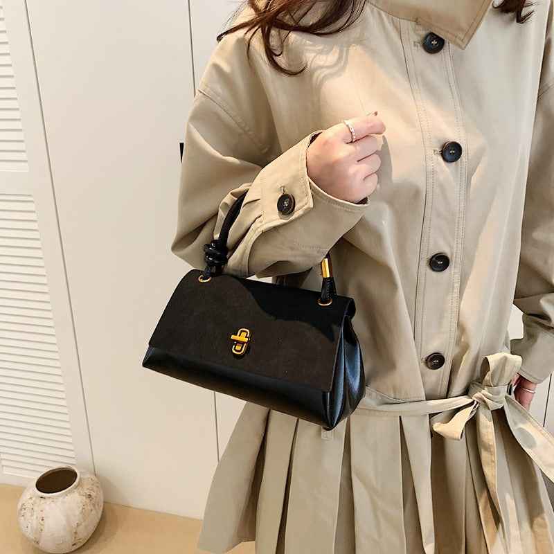 a lady carrying a black handbag