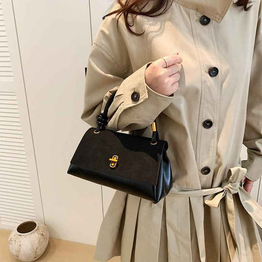 a lady carrying a black handbag