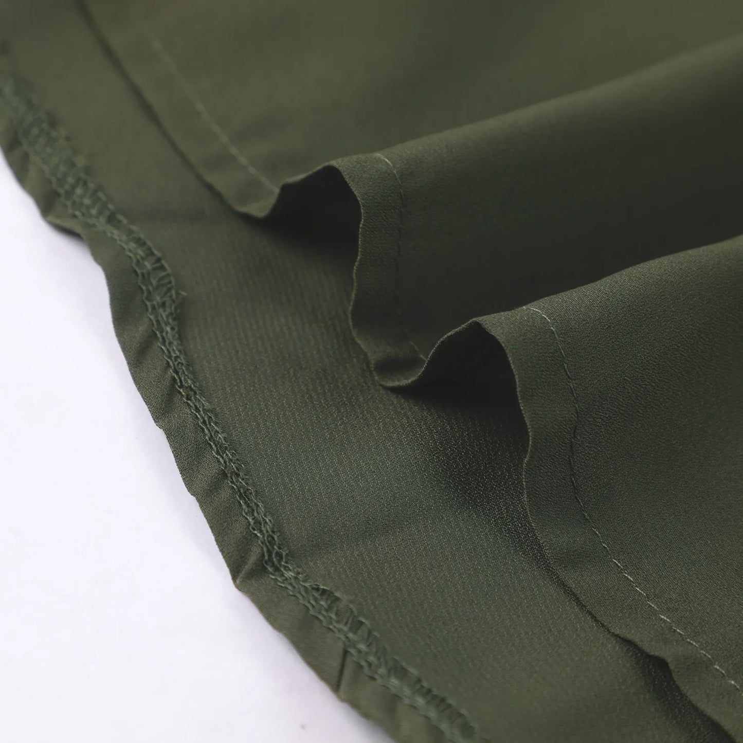 Gilded Printed Elegant Abaya by Trend Den, featuring a close-up of the soft, green fabric with a smooth hem.