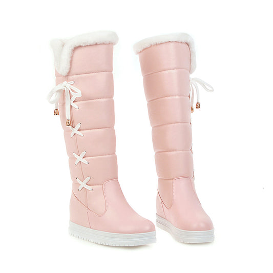 Pink knee-high boots with white fur lining on a white background