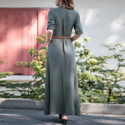 A woman wears an olive-green slim long dress in linen with shirt button front and braided brown belt detail