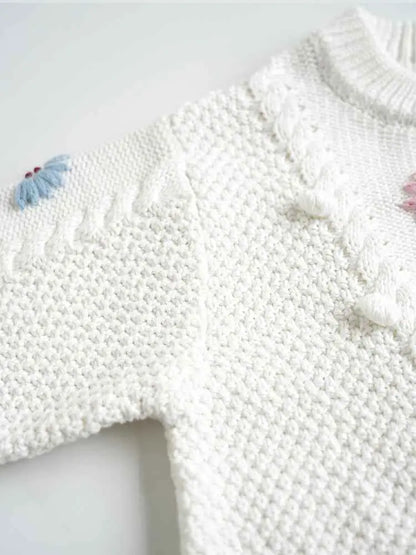 Baby girls hand-embroidered floral cotton sweater in white with textured cable knit and delicate blue and pink butterfly accents