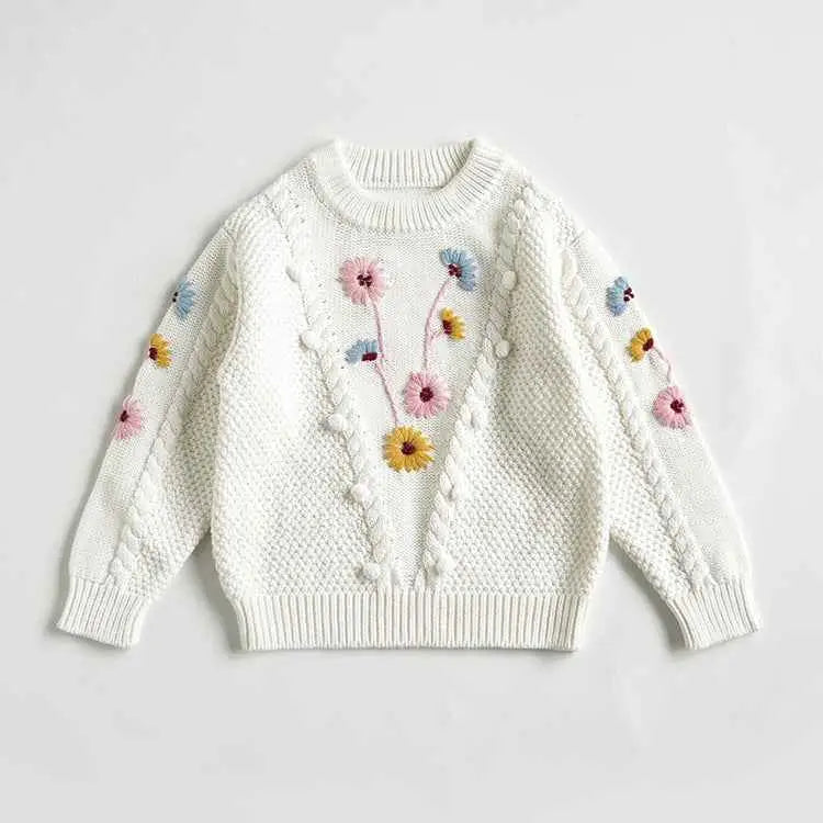 Baby girls white knitted sweater with hand-embroidered floral colorful flowers and pom-pom details from trend den