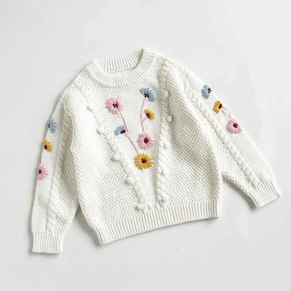 Baby girls hand-embroidered floral cotton white knitted sweater with colorful flowers and pom-pom details front trend den