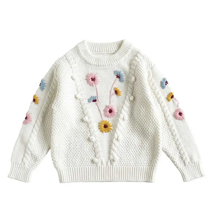 White knitted baby girls sweater with hand-embroidered floral pink yellow and blue flowers in floral cotton by trend den White
