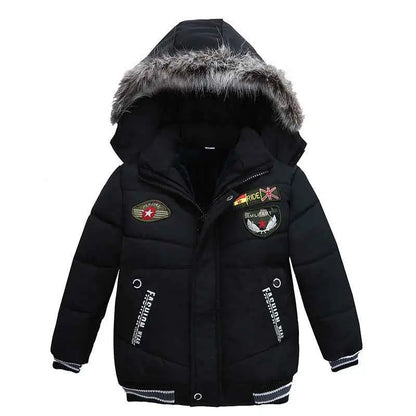 Boys cotton-padded winter jacket in black with fur-lined hood and decorative chest patches from trend den padded winter jacket 7style