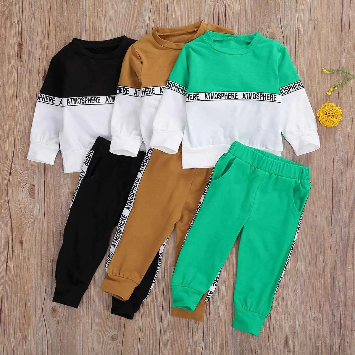 Boys long-sleeve letter suit and stretch trousers in solid black, mustard yellow, and green with white panels and atmosphere lettering