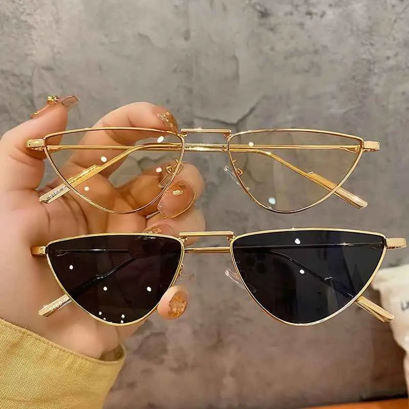 Gold-framed slim metal sunglasses with cat-eye shape and gradient dark lenses from trend den celebrity street-style collection