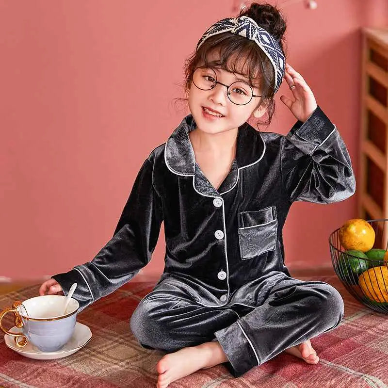 Children’s gold velvet cotton pajama set featuring black velvet with white piping and button closures from trend den Grey