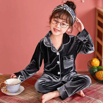 Children’s gold velvet cotton pajama set featuring black velvet with white piping and button closures from trend den Grey