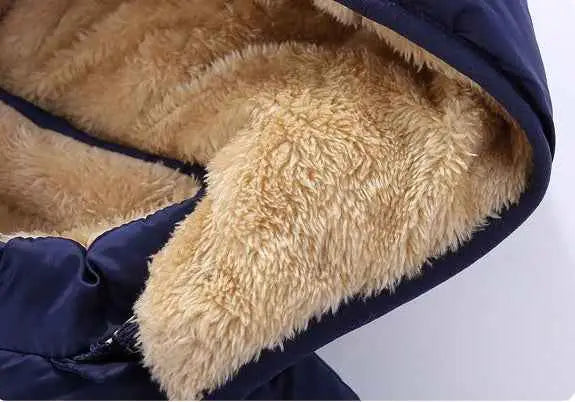 Children’s lambskin lined coat with tan faux fur lining and navy blue quilted outer fabric from Trend Den