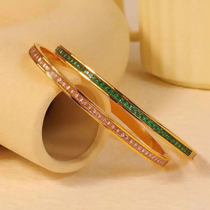 Gold-toned stainless steel crystal inlaid slim bangle with rectangular-cut pink and green gemstones