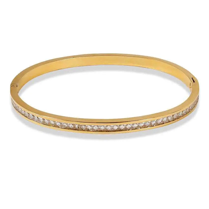 Gold-toned stainless steel crystal inlaid slim bangle bracelet with a single row of clear faceted stones