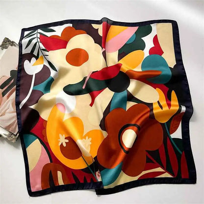 Vibrant dopamine-print silk feel square scarf with bold orange red teal floral pattern and dark navy border from trend den Dopamine Flower Black