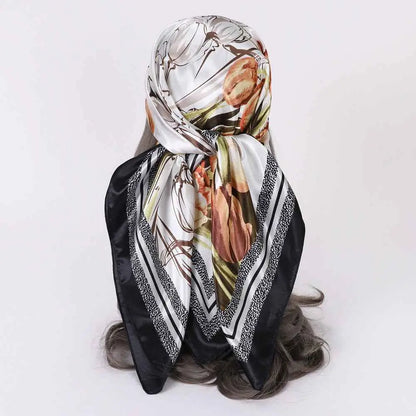 Elegant floral oversized 90cm x 90cm imitation silk scarf in white with bold black brown green and orange patterns from trend den