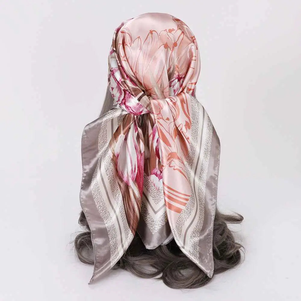 Elegant oversized floral 90cm x 90cm imitation silk scarf in soft pink and silver wrapped around head by trend den