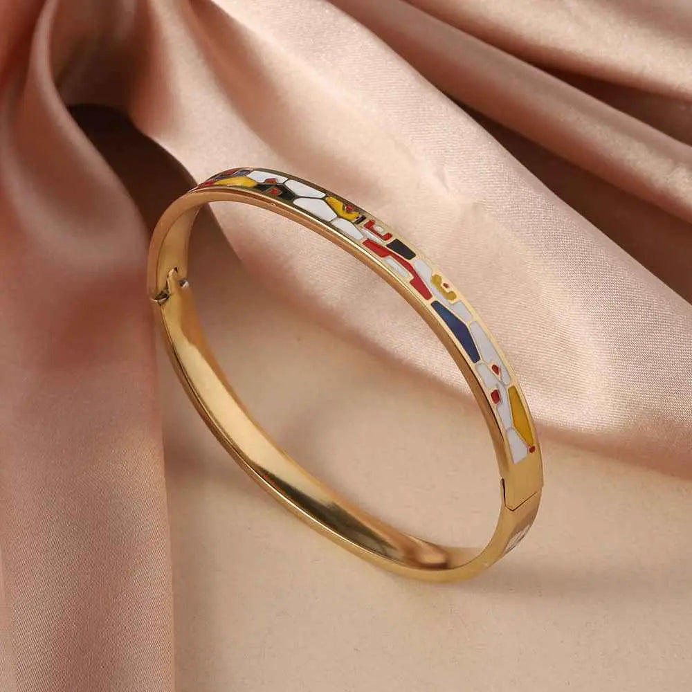 Floral enamel gold bangle in titanium steel featuring a vibrant abstract design with red yellow blue and white shapes Black And White Red