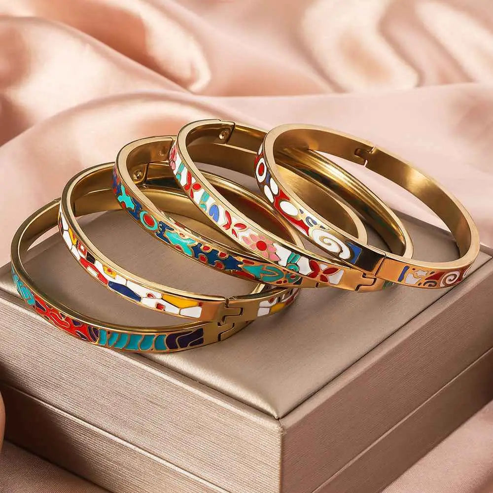 Set of five gold bangle titanium steel bracelets with floral enamel gold vibrant colorful patterns