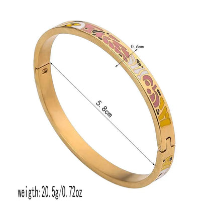 Gold bangle with colorful floral enamel patterns on inner edge made of durable titanium steel