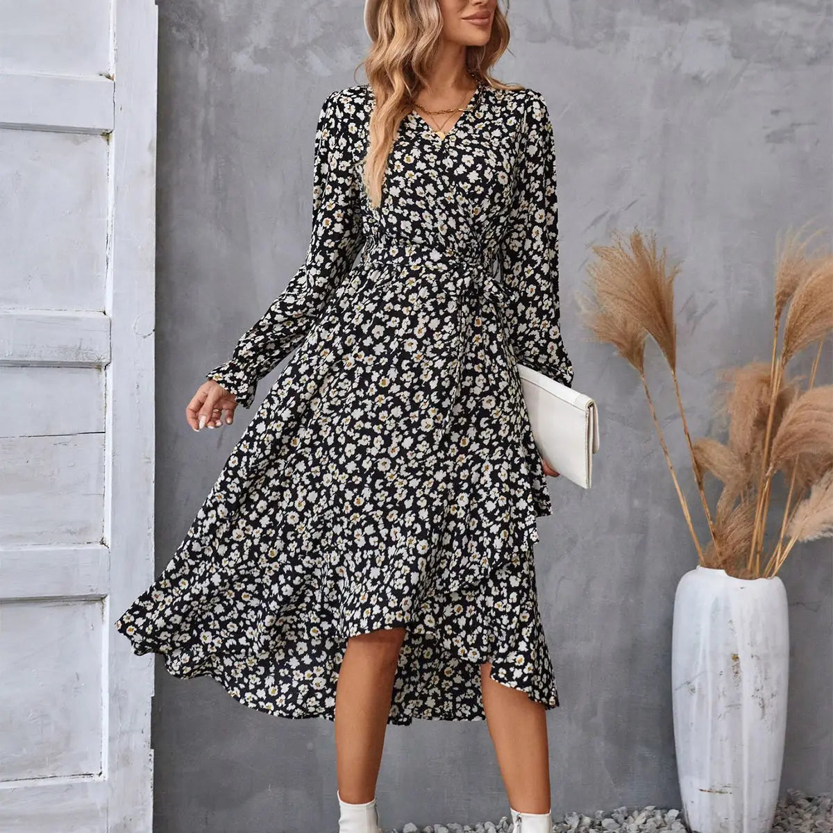 Black and white floral ruffled long sleeve wrap dress with v neckline cinched waist and asymmetrical hem
