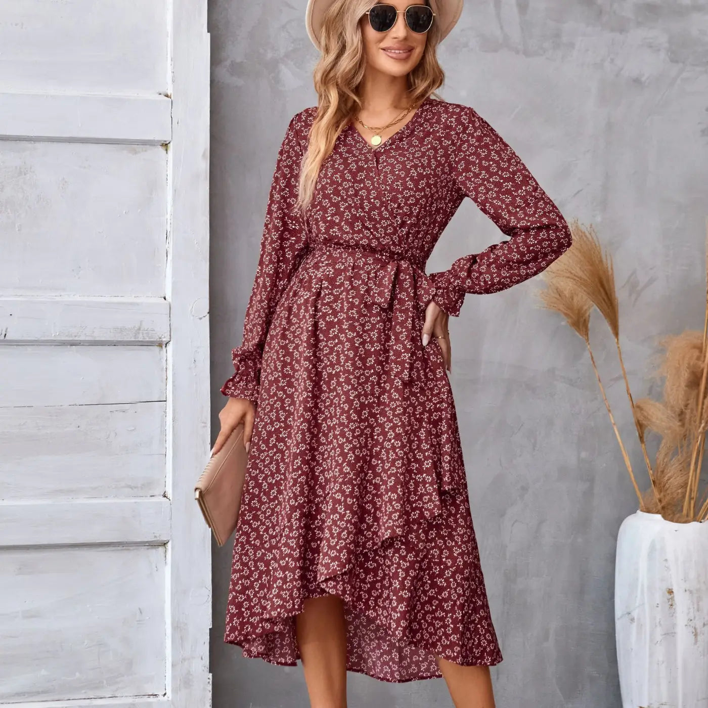 A flowing maroon floral ruffled long sleeve dress with midi length and a belted waist for elegant occasions Red