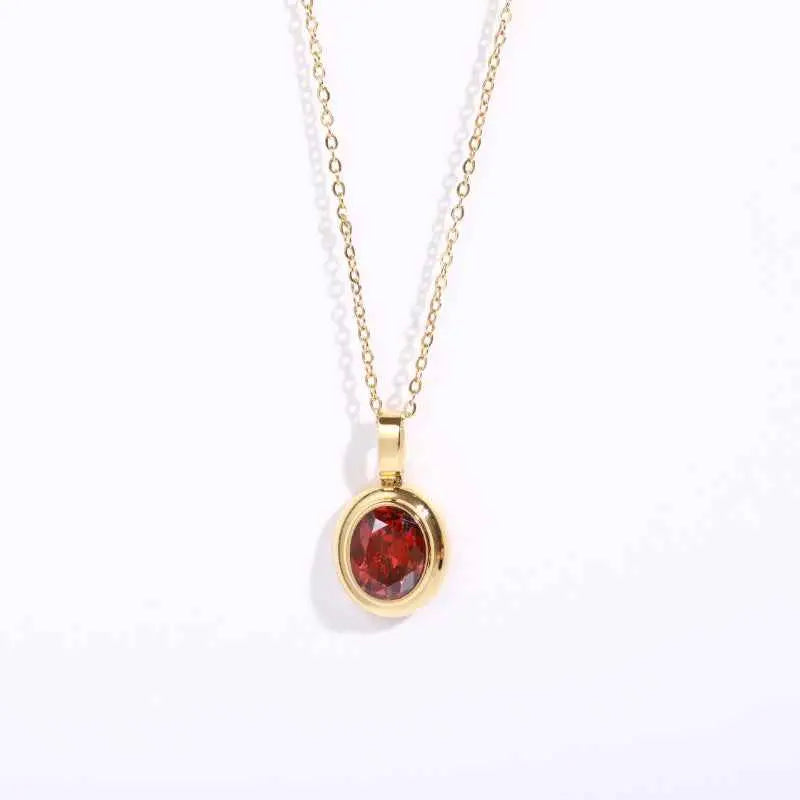Delicate 18k gold gemstone necklace with a deep red garnet stone in a smooth bezel from trend den collection Dark Red