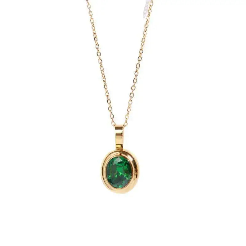 Delicate 18k gold gemstone necklace with a vibrant green emerald in a simple round bezel from trend den