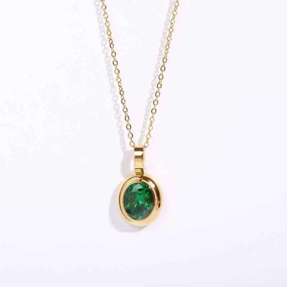 A delicate 18k gold gemstone necklace with an oval-cut emerald pendant in a polished gold bezel by trend den Green