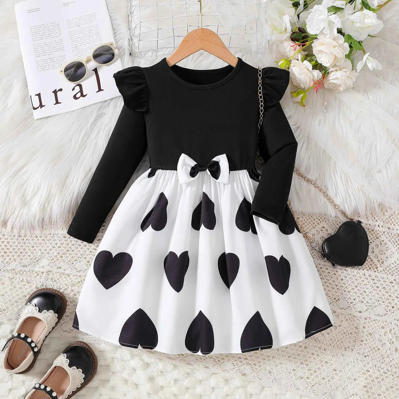 Black and white heart patterned toddler princess dress with ruffled sleeves and waist bow from trend den cartoon princess dress Black