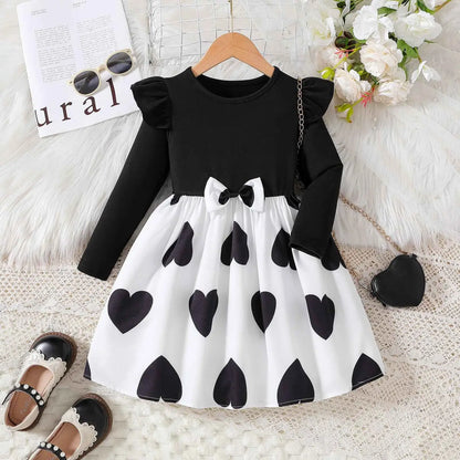 Black and white heart patterned toddler princess dress with ruffled sleeves and waist bow from trend den cartoon princess dress Black