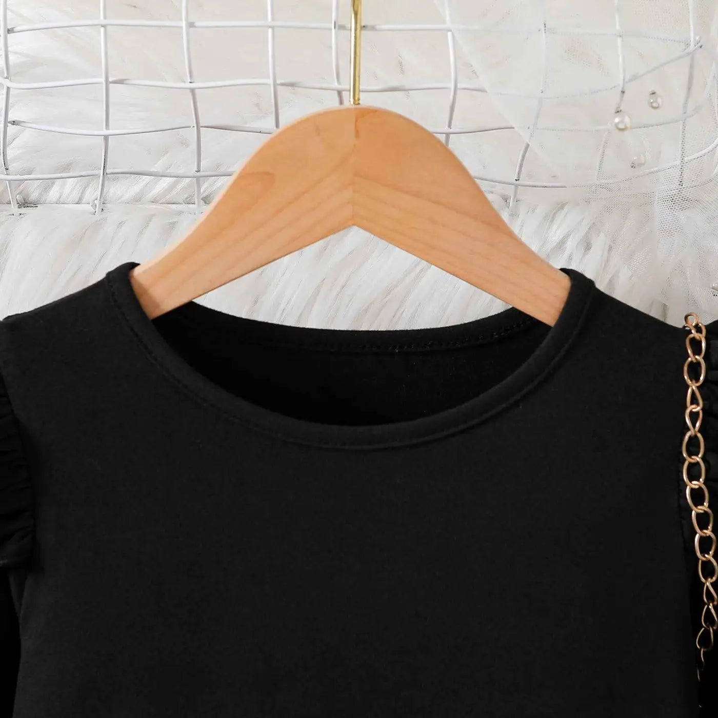 Black sleeveless top with round neckline and subtle shoulder ruching featured in girls cartoon princess dress trend den