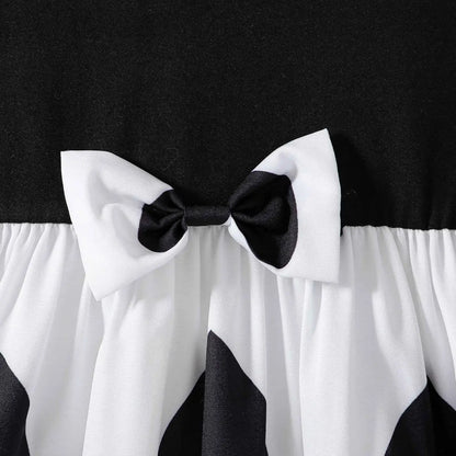Black and white satin bow adorns the waist of a girls cartoon princess dress from trend den
