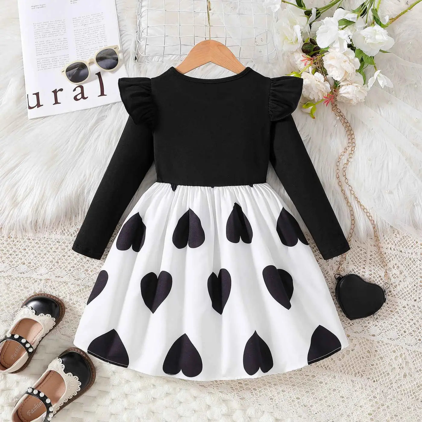 Girls cartoon princess dress featuring black and white heart pattern with ruffled sleeves from trend den