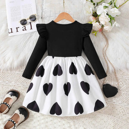 Girls cartoon princess dress featuring black and white heart pattern with ruffled sleeves from trend den