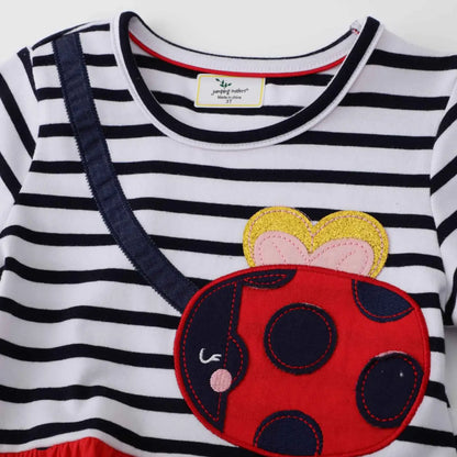 Girls casual print dress with white and navy stripes featuring a red ladybug appliqué and yellow gold heart head adornment