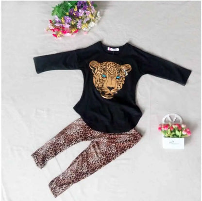 Black long-sleeved girls leopard print top with golden leopard face and striking blue eyes in a girls leopard print set Black