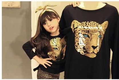 Black long-sleeved girls leopard print top with shiny gold leopard face and blue eyes in t-shirt and leggings set
