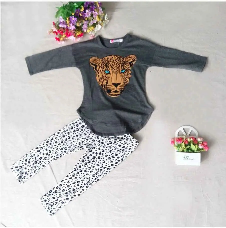 Gray long-sleeved girls leopard print top with detailed leopard face graphic featuring blue eyes and tan fur patterns Grey