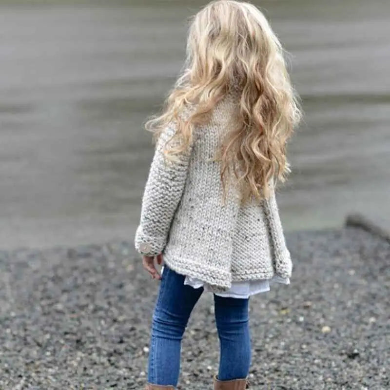 A child wearing an off-white girls rabbit hair blend knit cardigan with cozy textured stitches and subtle speckles