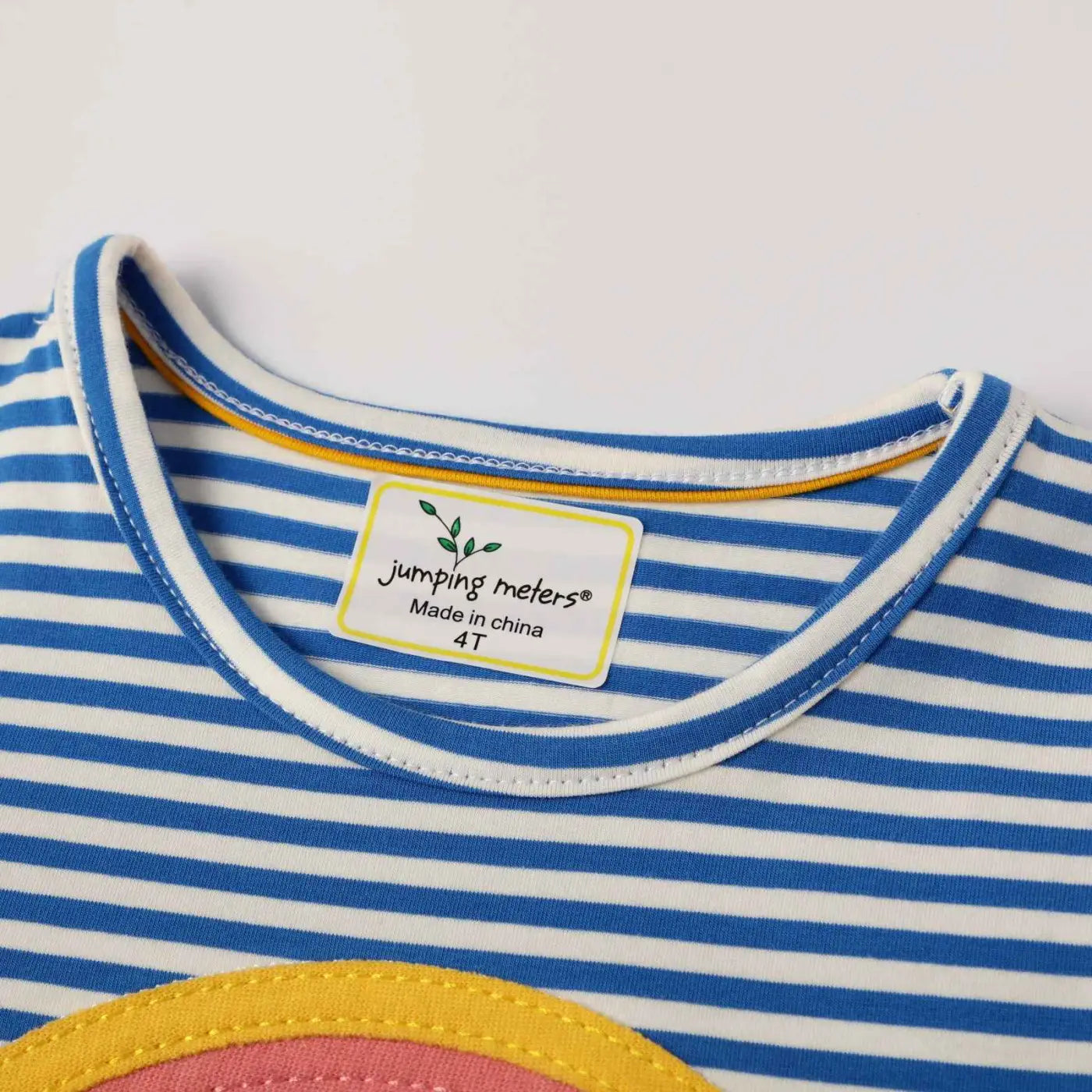 Girls rainbow stripe cotton dress featuring a blue and white striped top with yellow trim around the neckline from trend den