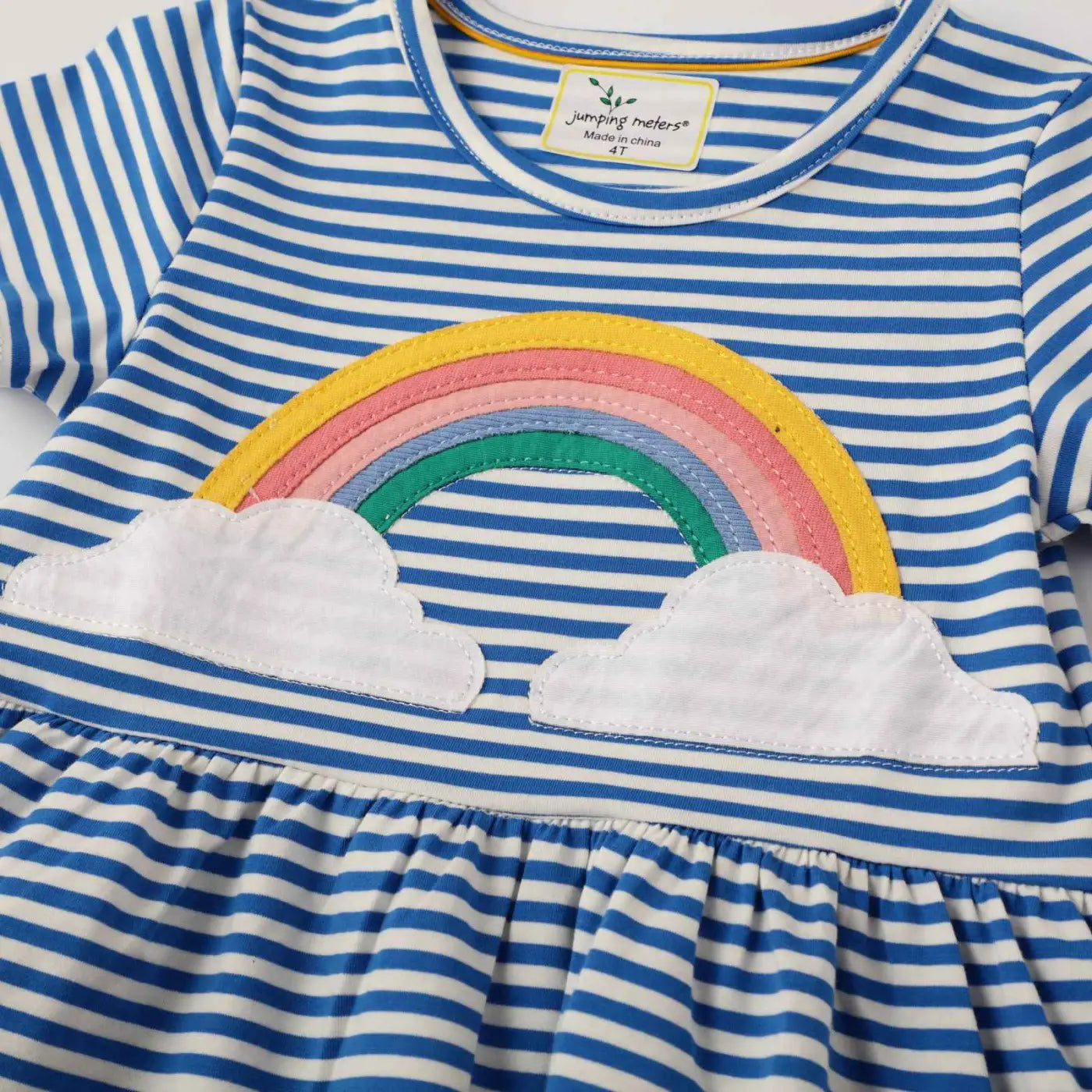 Girls rainbow stripe cotton dress with blue and white stripes and a colorful rainbow embroidered above white clouds