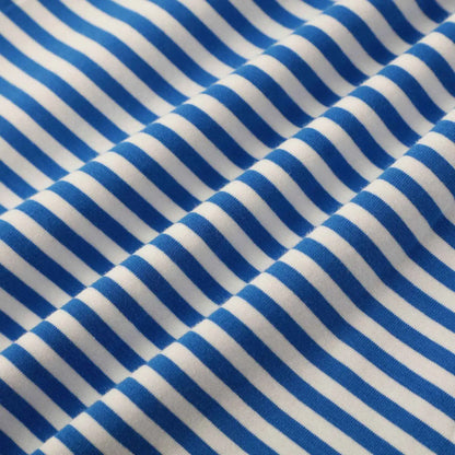 Blue and white woven cotton fabric detail of girls rainbow stripe cotton dress from trend den
