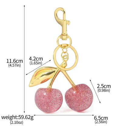 Glossy cherry bag charm keychain with pink glitter and zinc alloy gold-tone stem and leaves from trend den Pink