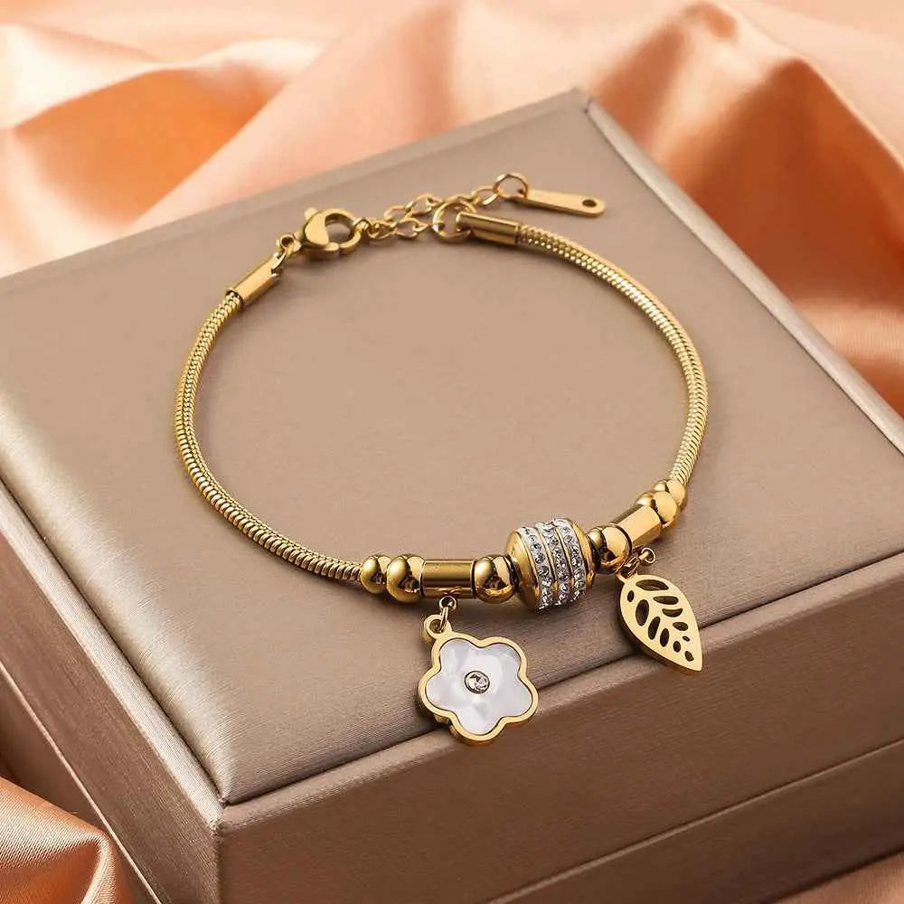Gold shell charm bracelet with gold-toned snake chain titanium steel featuring crystal bead and floral leaf charms Five Petal Flower