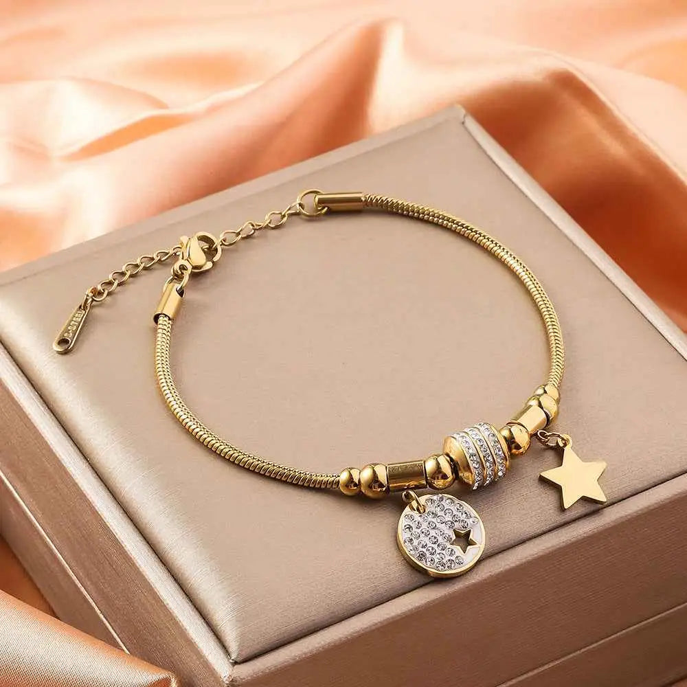 Gold shell charm bracelet with gold-toned snake chain titanium steel featuring crystal charm and star pendant
